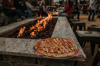 A delicious pizza warms by fireside at Boxcar Bar Arcade in Durham, NC.