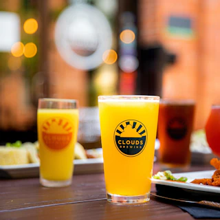 Draft beers and plates of food at Clouds Brewing in Durham, NC.