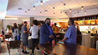 People gather in a modern style room at the Black Founders Exchange event in Durham.