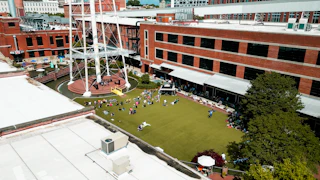 Concert goers sit on the lawn at ATC during the Biscuits and Banjos Festival.
