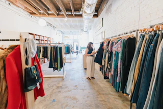 A woman browses the racks in a Durham, NC vintage clothing store