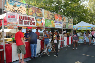 Festival goers line up to get fair food at a stand at CenterFest.
