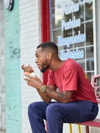 A man enjoys a cup of ice cream outside of Pincho Loco in Durham, NC.