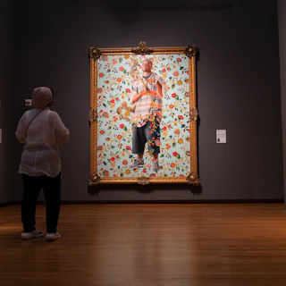 A guest views St. John the Baptist II, by Kehinde Wiley at The Nasher Museum of Art.