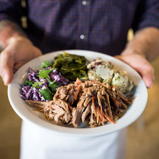 waiter holding plate of food