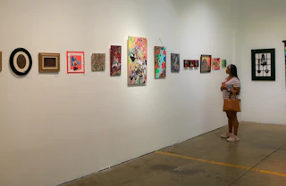 A guest gazes at art on a wall at The Scrap Exchange in Durham, NC.