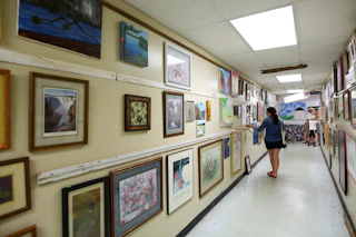 A shopper peruses local art at Scrap Exchange in Durham, NC.