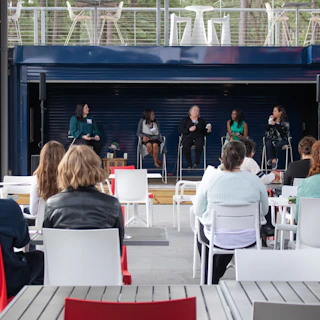 An audience enjoys a panel talk in the central courtyard of Boxyard RTP.