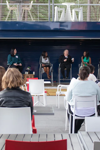 An audience enjoys a panel talk in the central courtyard of Boxyard RTP.