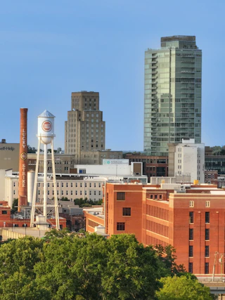 The Lucky Strike tower stands in front of skyscrapers in Downtown Durham.